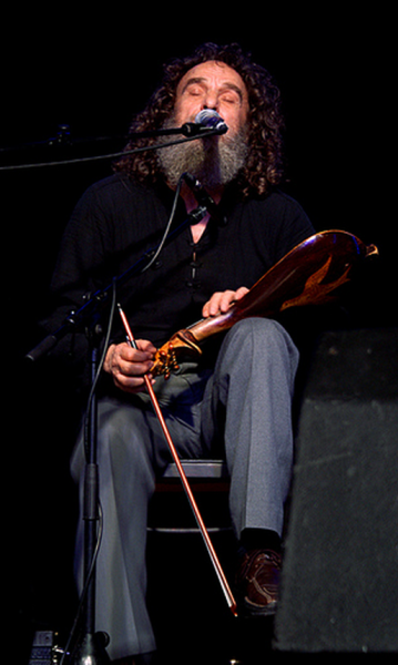 Explore the timeless artistry of Psarantonis, captured during his performance at the 'All Tomorrow's Parties' festival in 2007, blending Cretan tradition with raw emotion.